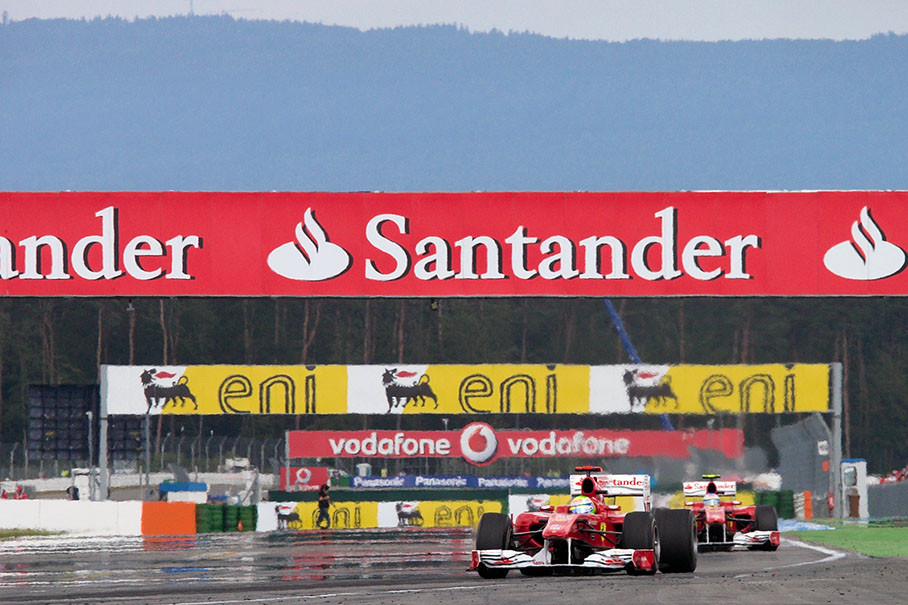Felipe Massa enters the 'Motodrom' in front of Ferrari team mate Alonso