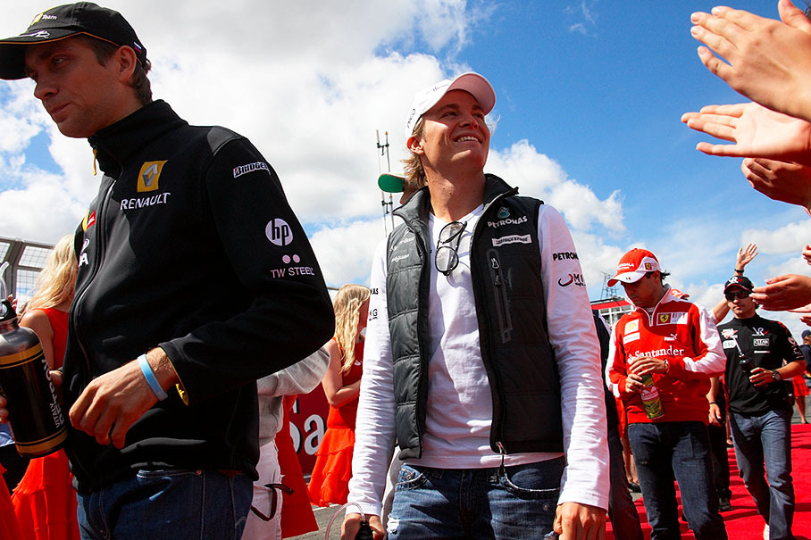 Vitaly Petrov of Renault and Mercedes star Rosberg walk to drivers parade
