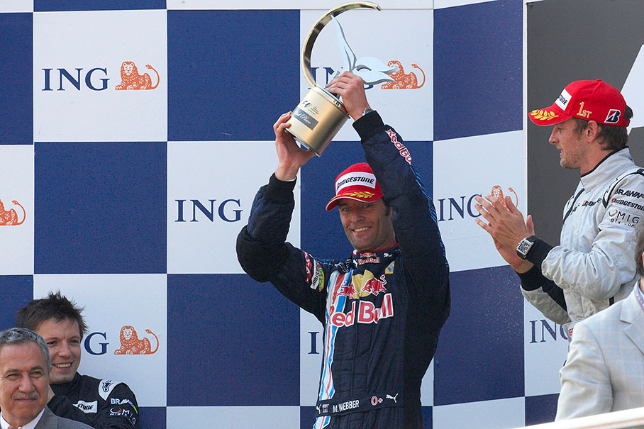 Red Bull's Mark Webber shakes his trophy for second place
