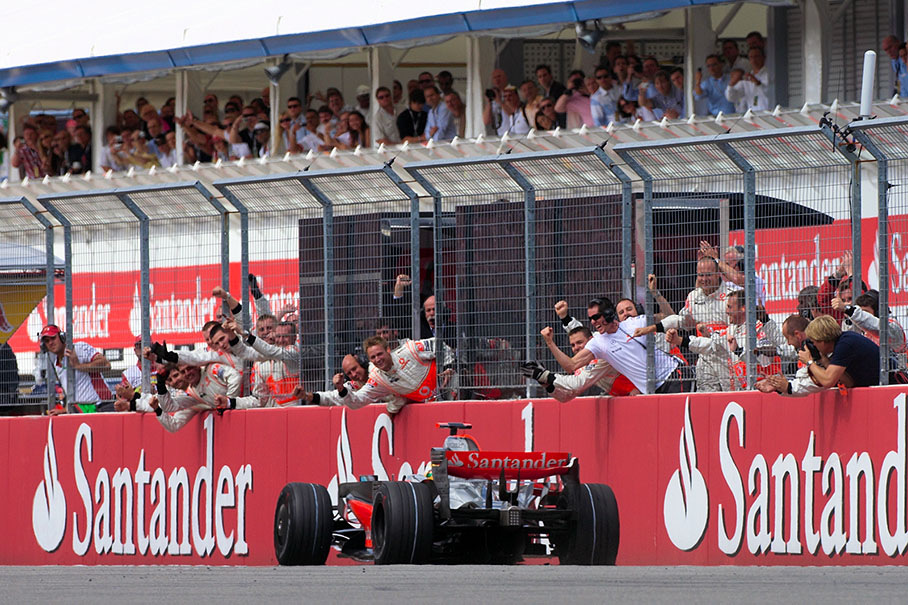 Lewis Hamilton passes his cheering team and wins the German Grand Prix