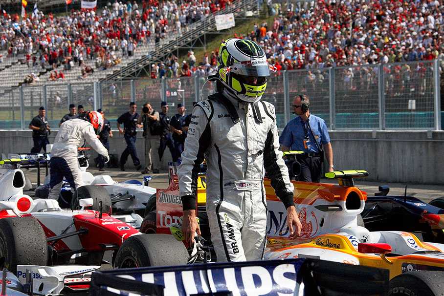 Jenson Button walks through parc ferme after the race