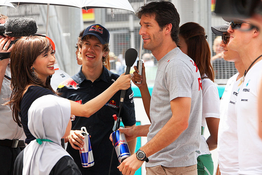 Red Bull drivers Sebastian Vettel and Mark Webber are being interviewed on the grid