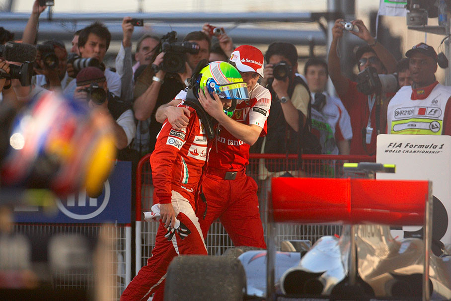 Second placed Felipe Massa is being guided through an emotional parc ferme by his Ferrari teammanager Stefano Domenicali