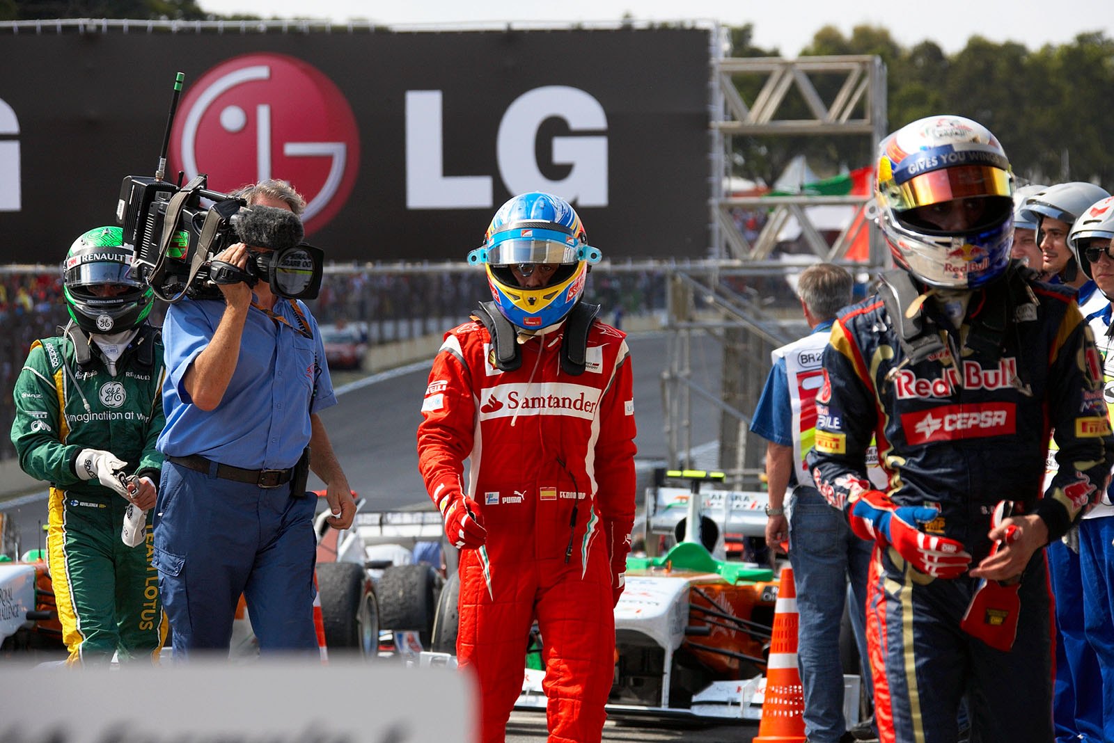 The other race drivers - Buemi, Alonso and Kovalainen - have finished the race and walk towards parc ferme after the Brazilian Grand Prix