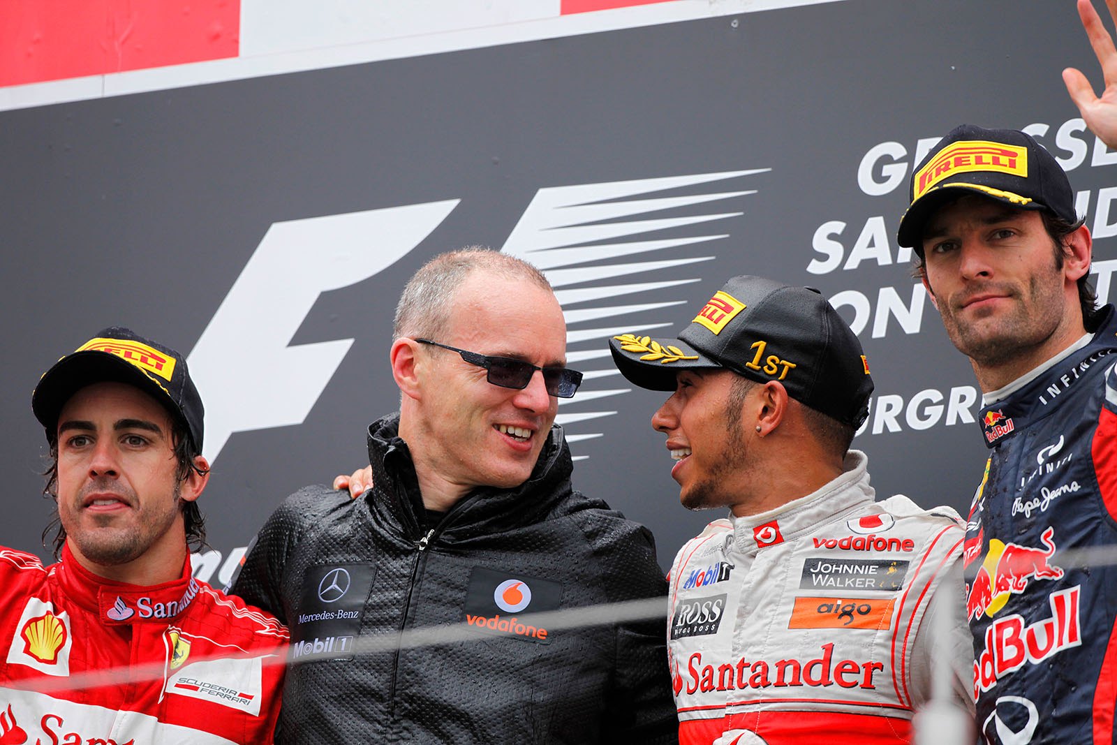 Final podium ceremony group photo of second placed Fernando Alonso of Ferrari, McLaren operations director Simon Roberts, race winner Lewis Hamilton and third placed Mark Webber