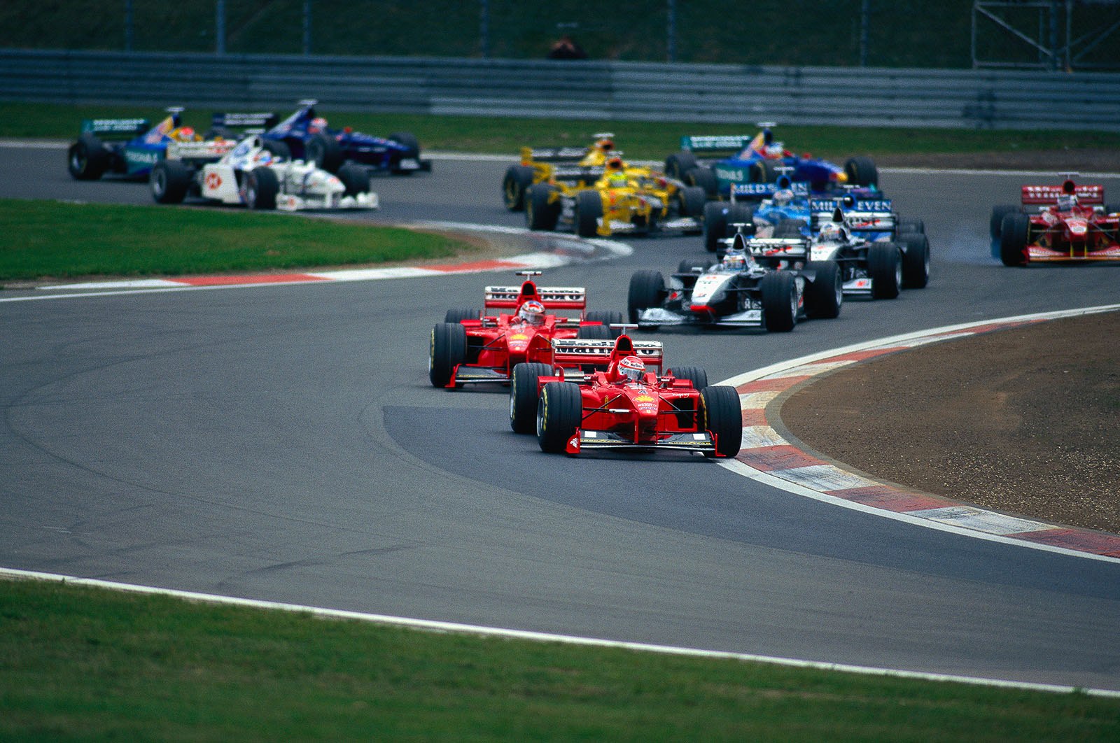 Luxembourg GP 1998: Eddie Irvine, Ferrari, in the lead, followed by Schumacher, Hakkinen and Coulthard