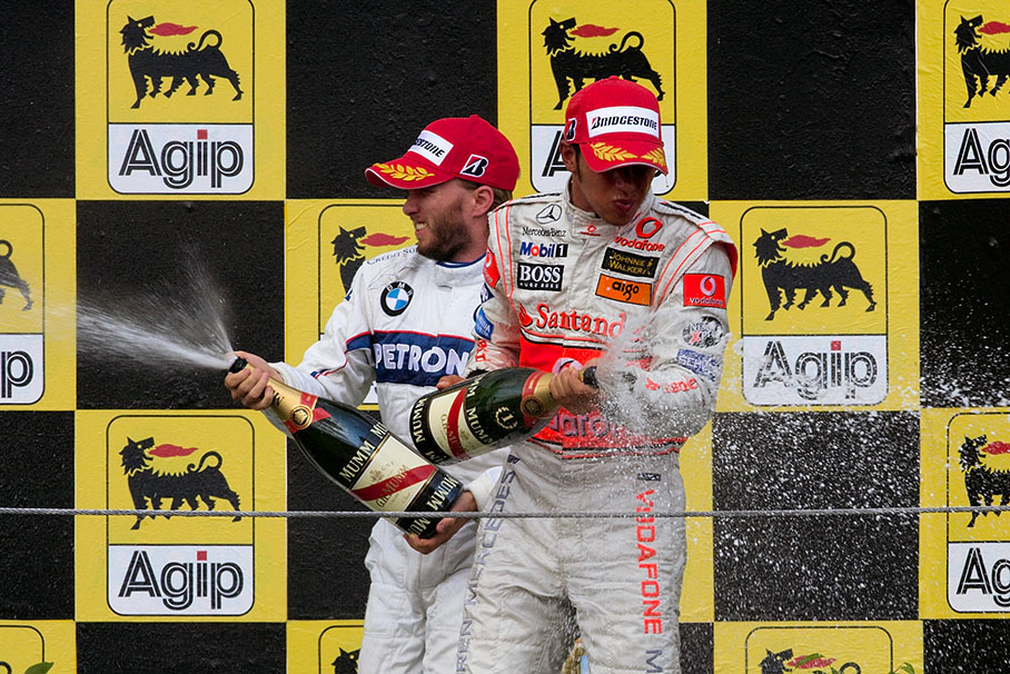 Hamilton and Heidfeld spray champagne