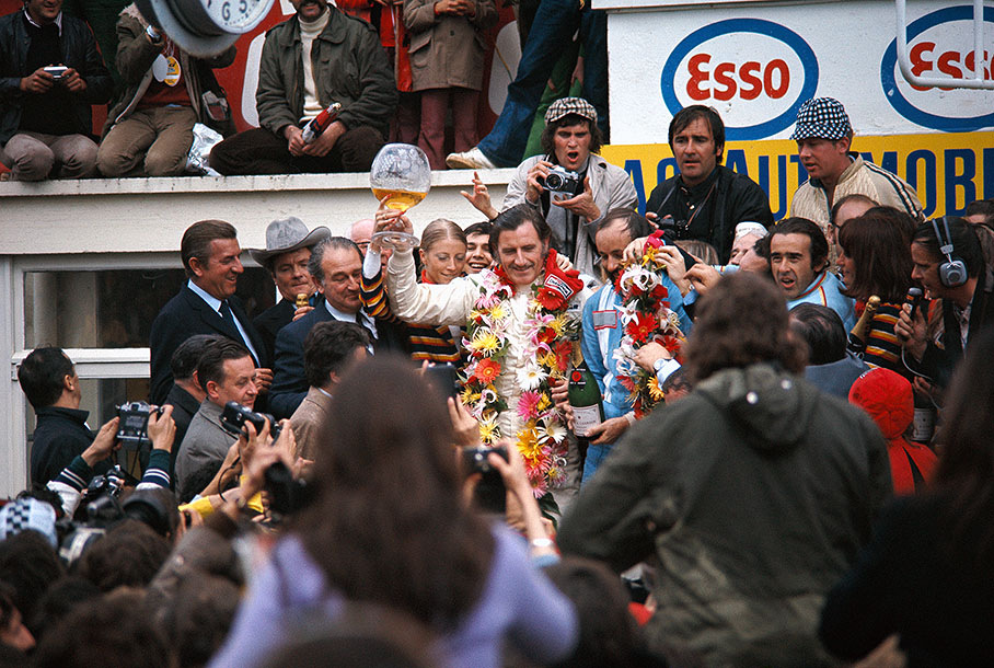 Race winners Graham Hill (GB) and Henri Pescarolo (F) celebrate their victory on podium