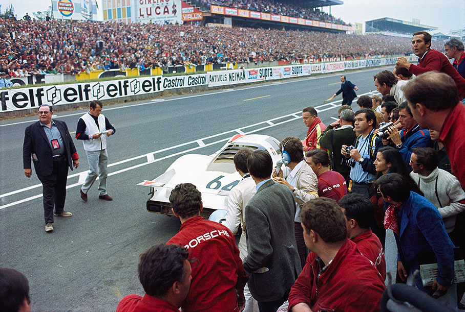 Porsche company's Chief Development Engineer Helmut Bott watches a pit stop of the winning prototype (overall second placed) Porsche P908L 031 #64 driven by Hans Herrmann (D) and Gerard Larrousse (F)