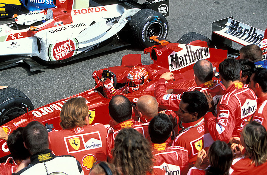 Michael Schumacher with cheering team in parc fermé