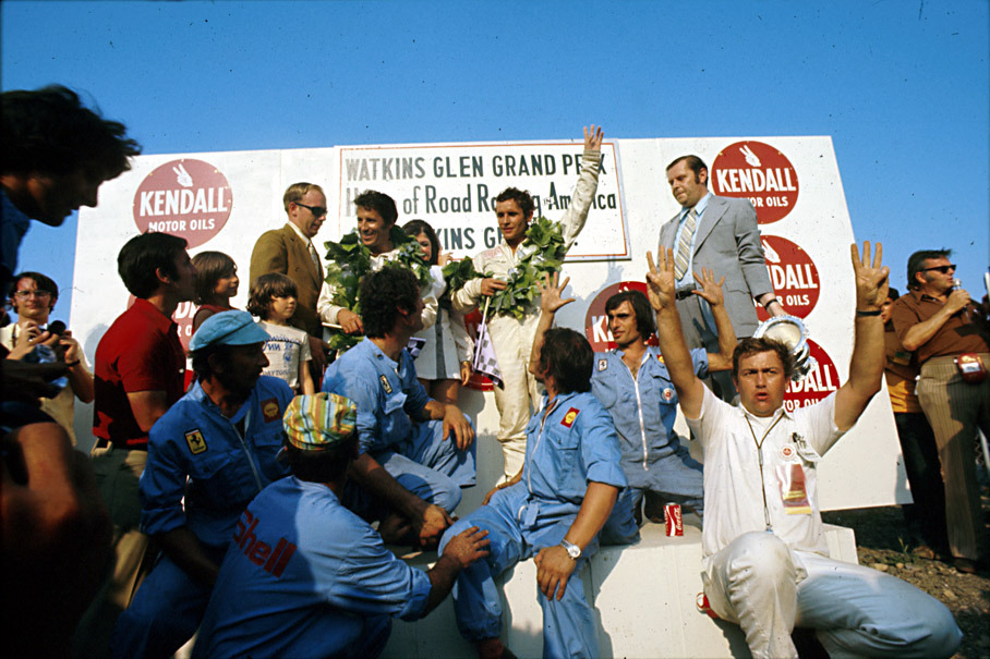 Mario Andretti (USA) and Jacky Ickx (B) on the podium with the winning Ferrari team members