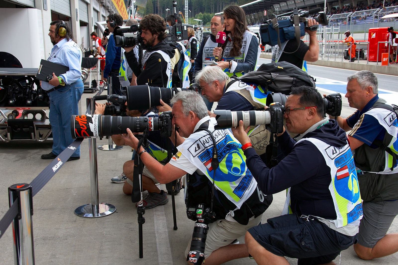 Photographers in front of the McLaren pits