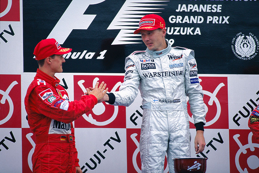 GP winner and defending world champion Mika Hakkinen receives a friendly handshake from his pursuer Michael Schumacher
