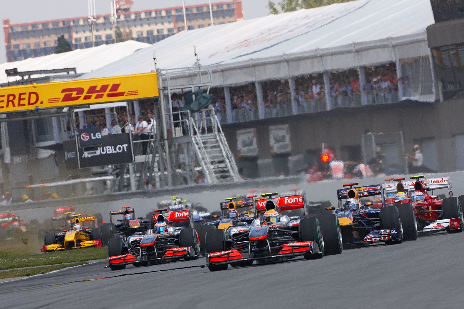 After the start, Hamilton leads in front of Vettel, team mate Button - and the lawnmowing Petrov in the back