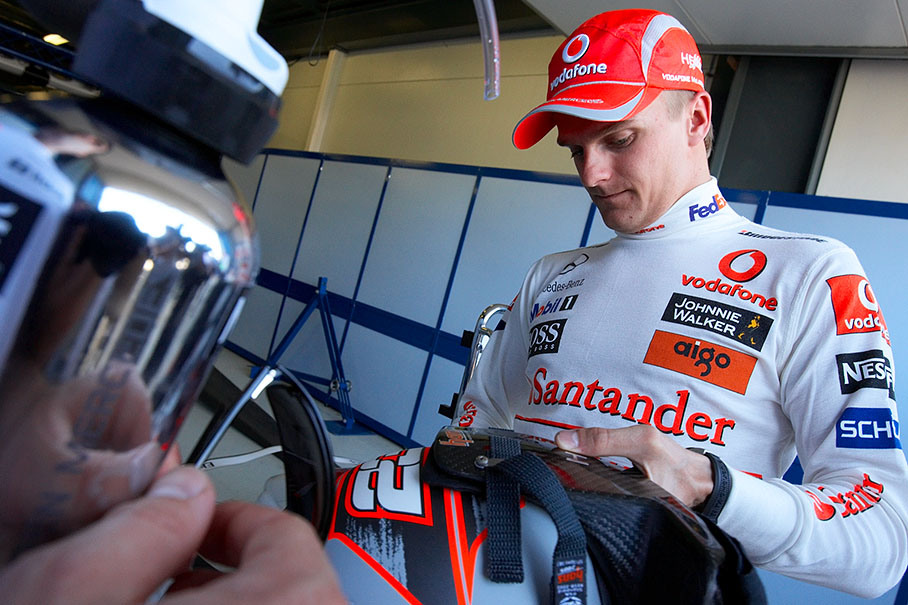 New McLaren driver Heikki Kovalainen checks his helmet design