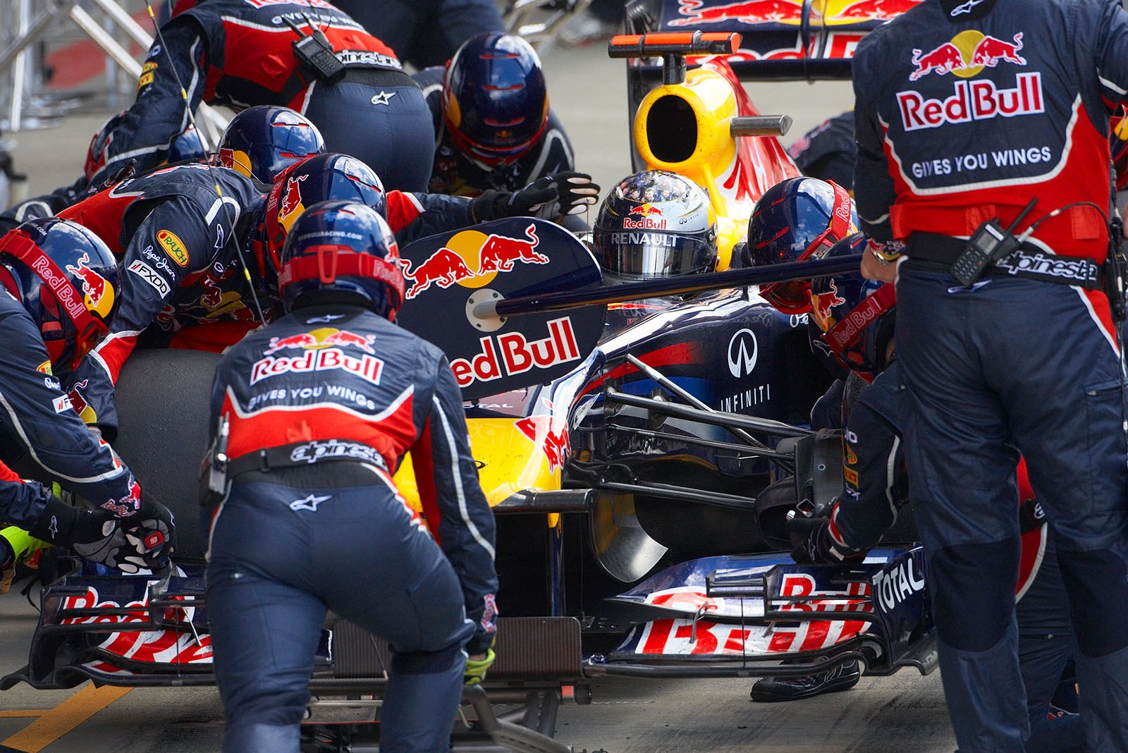 Sebastian Vettel is serviced at Red Bull Racing pits