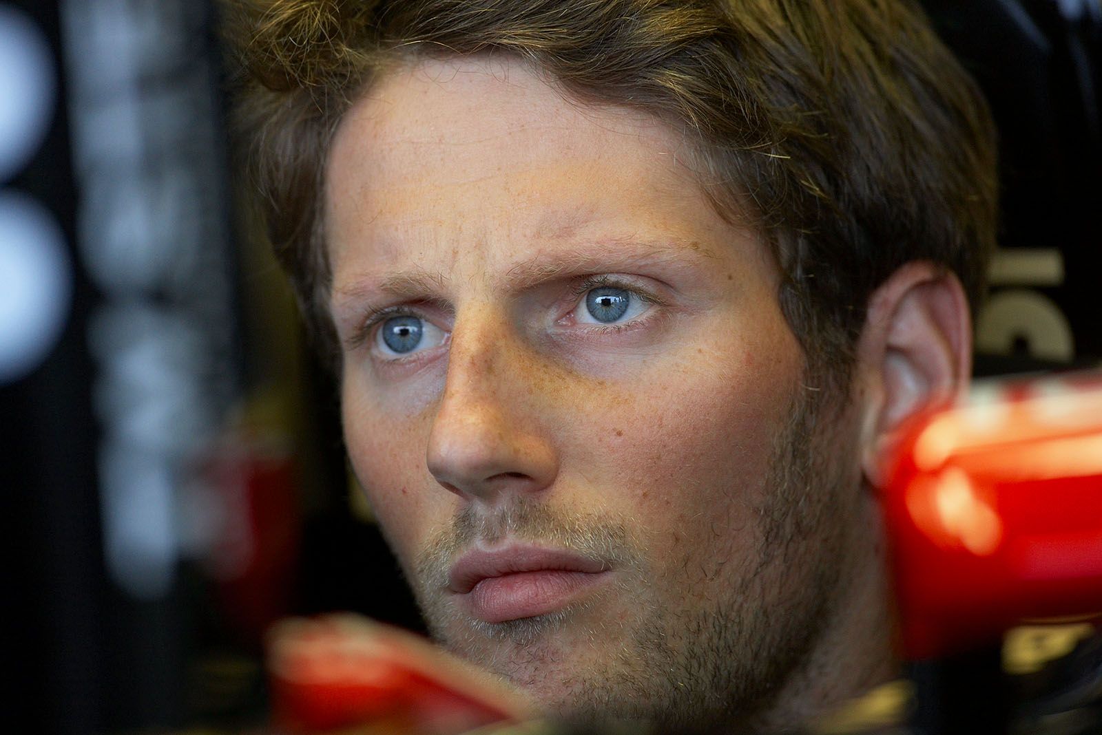 Romain Grosjean looks at the screen in Lotus pits