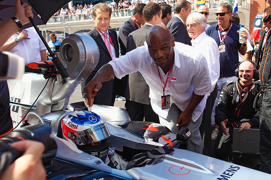 Mike Tyson pointing on McLaren-Mercedes driver Kimi Raikkonen on the grid before the start.