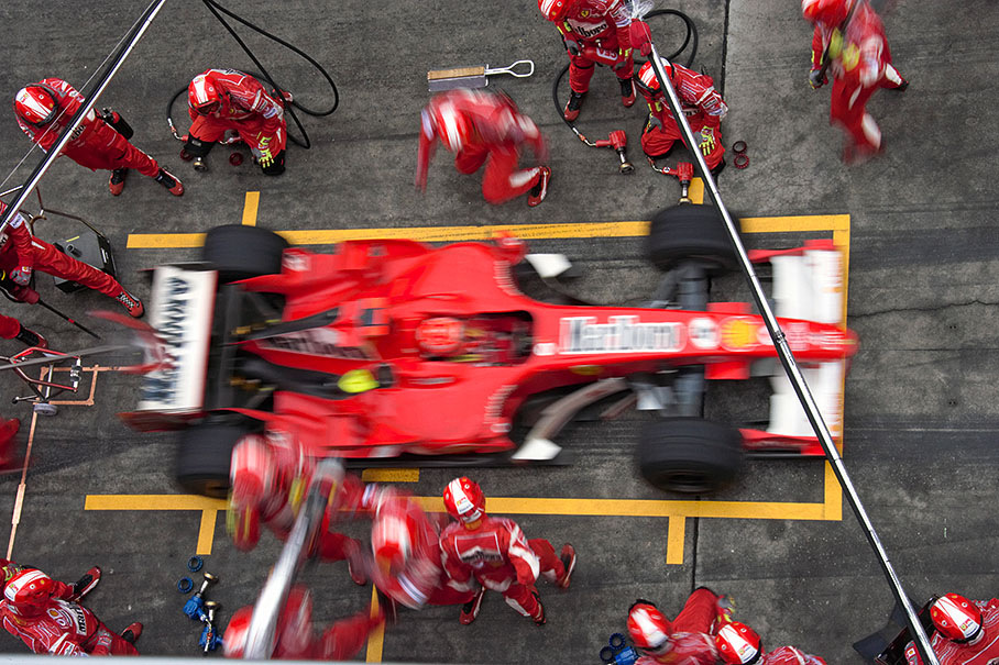 Michael Schumacher performing his first pit stop in lap 21