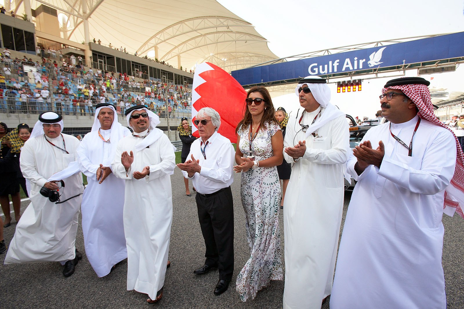 Formula One Group CEO Bernie Ecclestone walks the grid with his wife Fabiana Flosi and the Bahrainian rulers