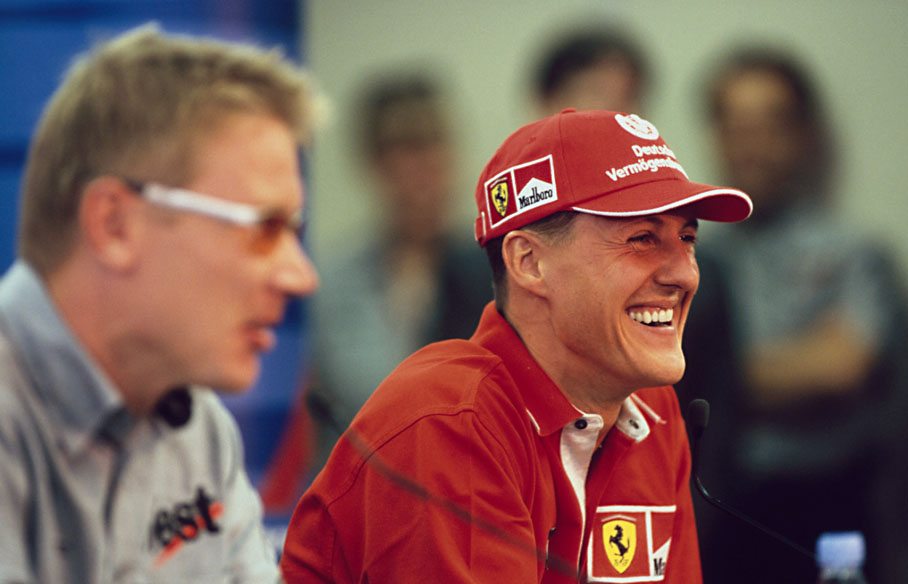 Michael Schumacher and Mika Häkkinen joke around during press conference