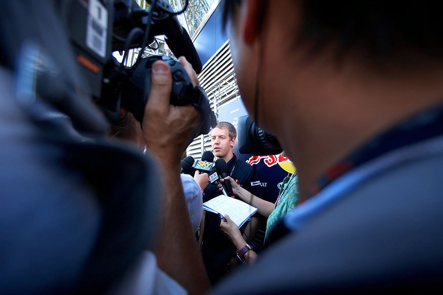 Red Bull's sunnyboy Sebastian Vettel surrounded by the international press