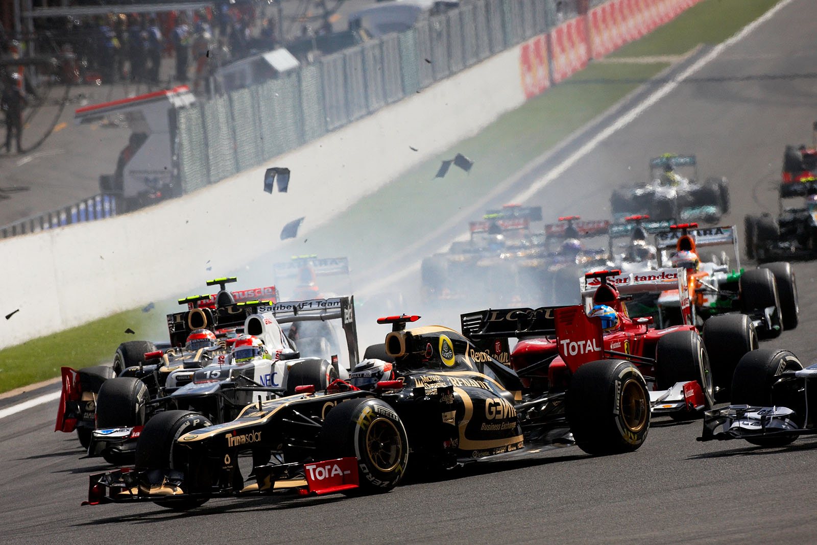 At the start of the Belgian Grand Prix 2012, the start field approaches turn one with pole setter Button in lead whilst Grosjean causes the accident