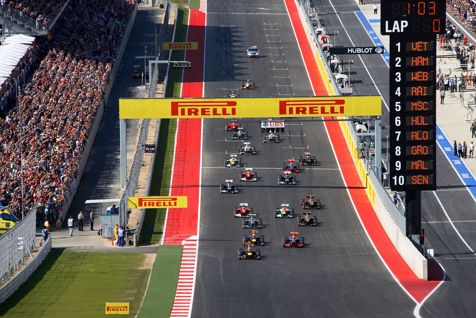 At the start, Sebastian Vettel of Red Bull Racing leads in front of McLaren's Hamilton and team mate Webber