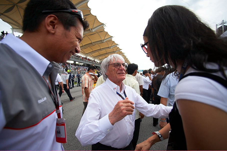 Bernie Ecclestone welcomes VIP guests on the grid