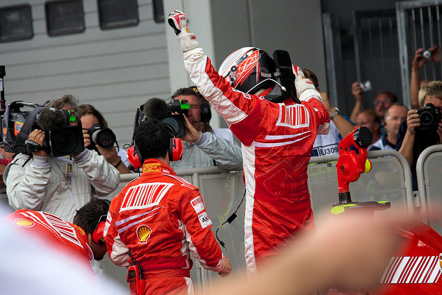 Kimi Raikkonen celebrates his pole position in parc fermé