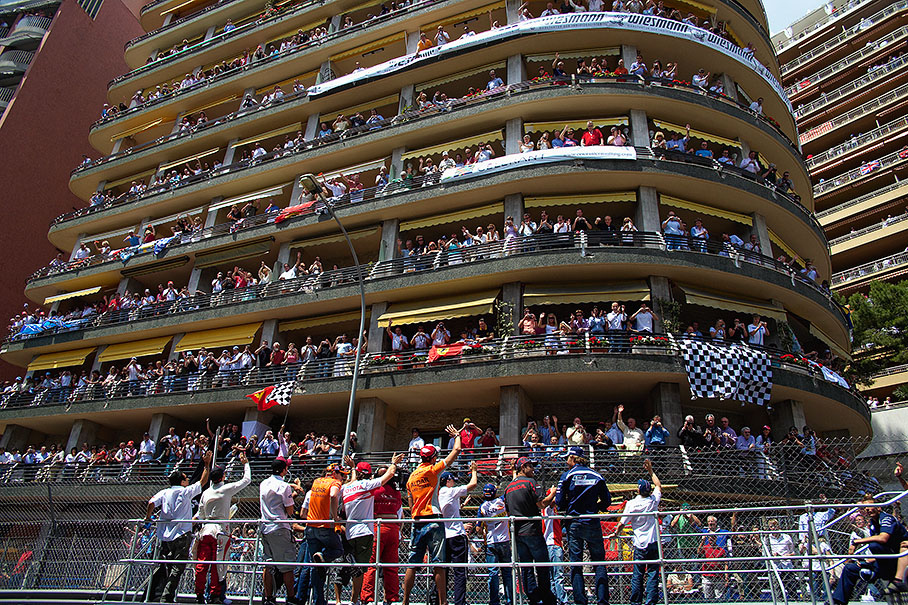 Drivers parade passes crowded balconies