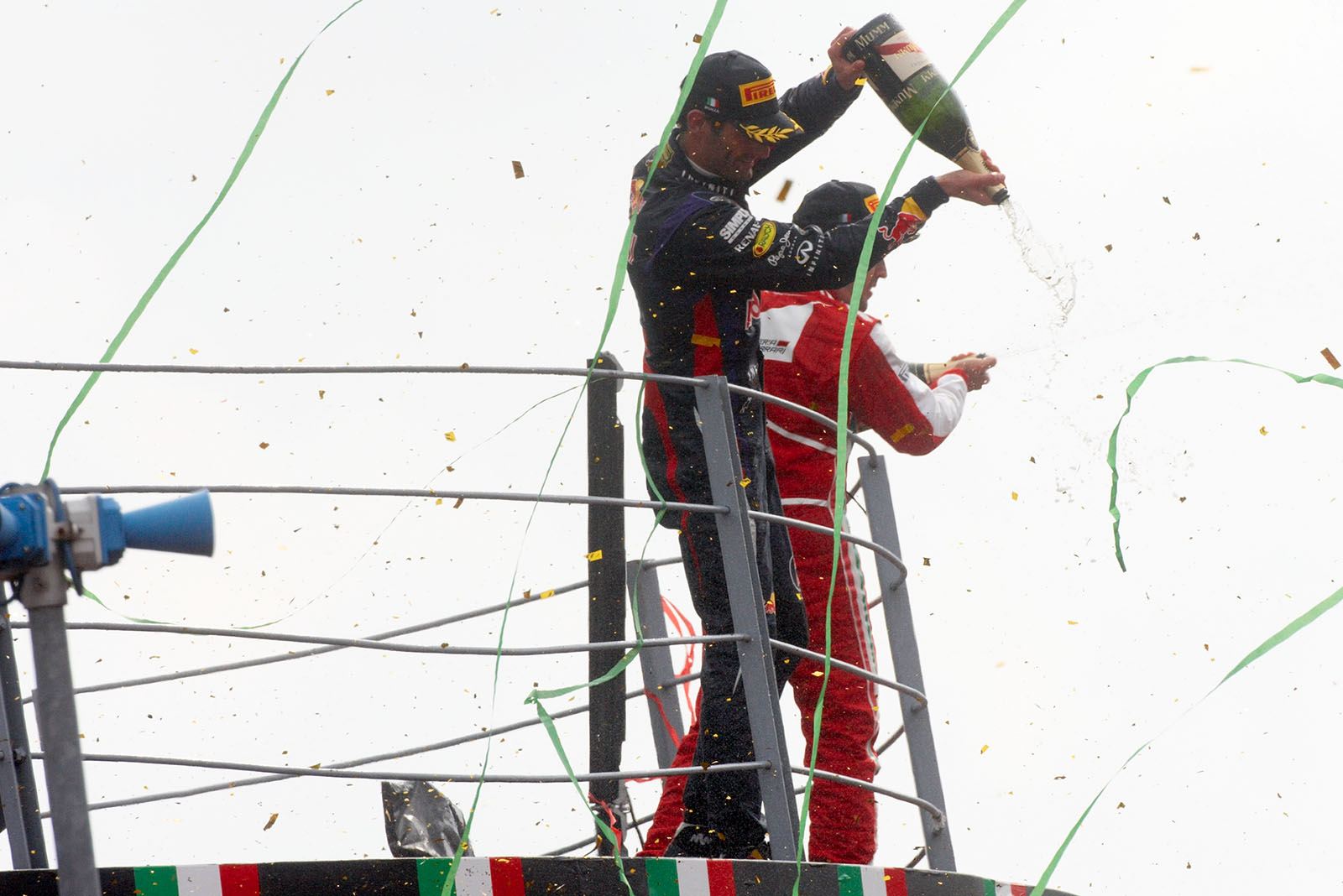 RBR's race winner Sebastian Vettel sprays champagne together with Ferrari's second placed Alonso during the podium ceremony after the Italian Grand Prix in Monza 2013