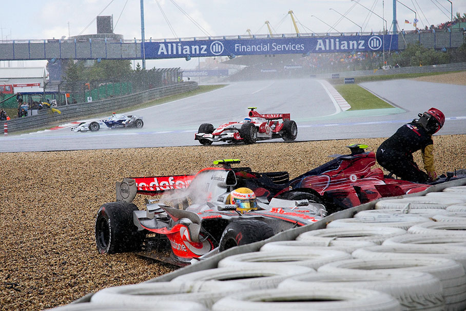 Heidfeld manages to keep his car on track while many other cars meet in the gravel