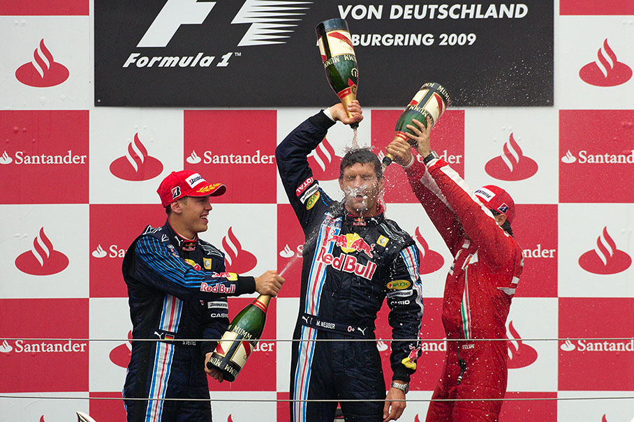 Champagne showers for Red Bull's race winner Mark Webber, celebrating his first Grand Prix victory