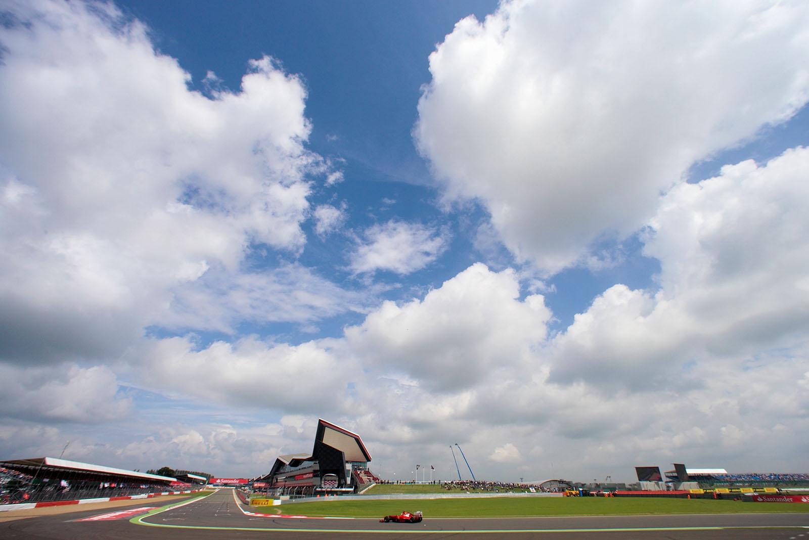 A lonely Ferrari races under a cloudy sky