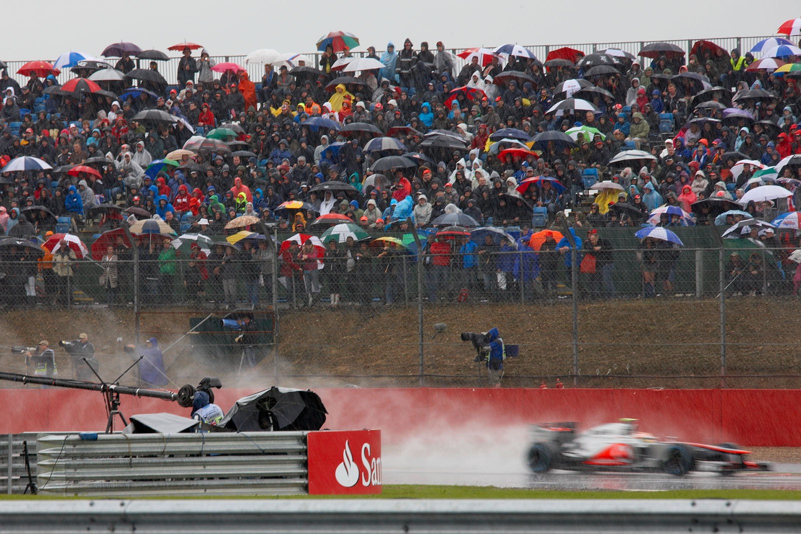 Lewis Hamilton's McLaren Mercedes passes a full stand during a rain session