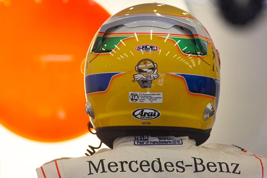 Lewis Hamilton puts his helmet on in McLaren pits