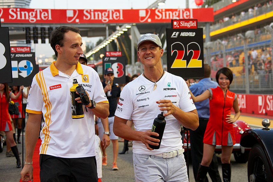 Renault's Robert Kubica and Michael Schumacher of Mercedes GP walk to drivers parade