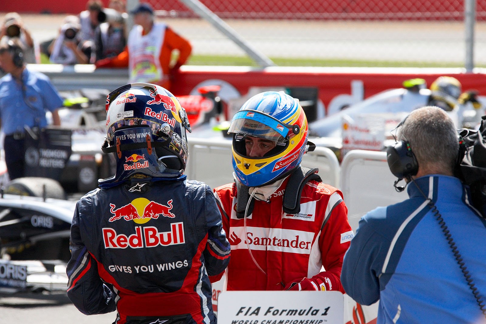 Race winner Fernando Alonso of Ferrari receives congratulations from second placed Sebastian Vettel of Red Bull in parc ferme