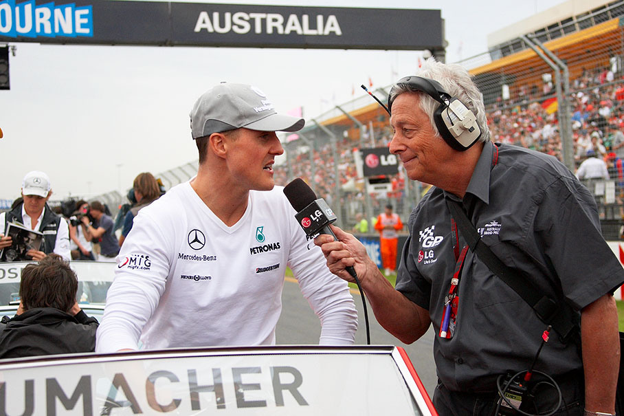 Bob Constanduros, on-circuit commentator at all Grands Prix, interviews Michael Schumacher at drivers parade