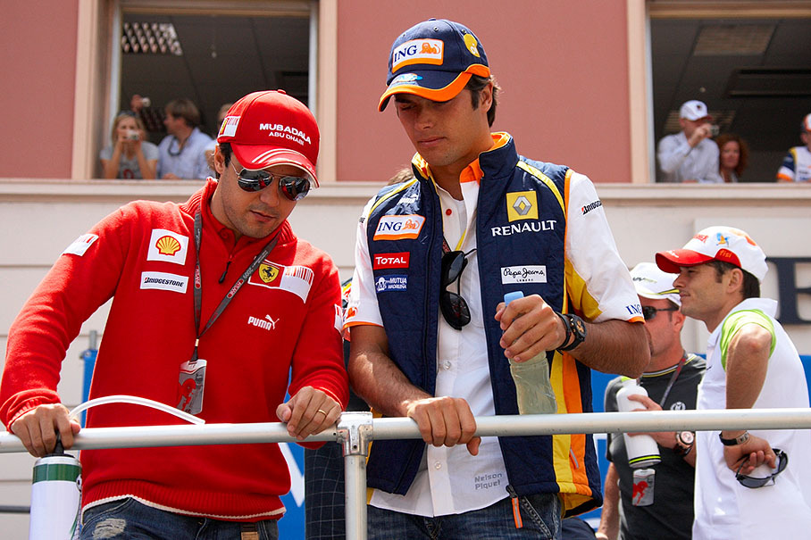 The two brazilian drivers Massa and Piquet chat on the drivers parade truck