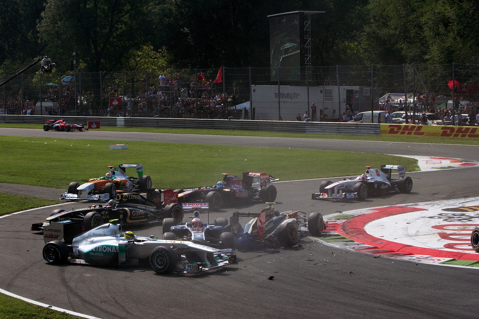 After the start field squeezed through turn one, Vitantonio Liuzzi of HRT crashed into the queue and ends the race for Nico Rosberg, Vitaly Petrov and nearly also for Rubens Barrichello