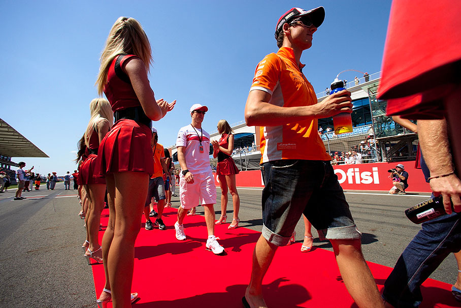 Ralf Schumacher and Adrian Sutil walk to drivers parade truck