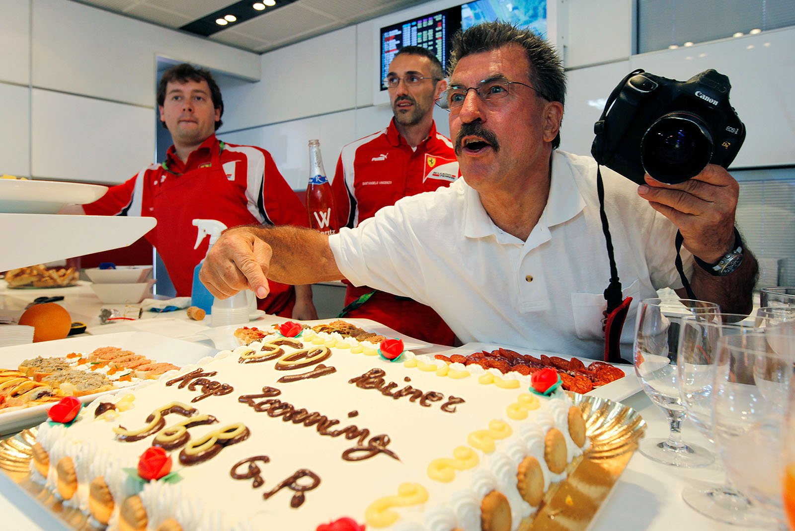 Rainer Schlegelmilch's surprise party in the Ferrari motorhome includes a new honoury pass, drinks, fingerfood and a huge cake - 50 Years in Formula One, 568 Grands Prix - Keep Zooming, Rainer! (Mille grazie a Stefano, Luca, Vincenzo e Vittorio!) Photo © Trenkler's