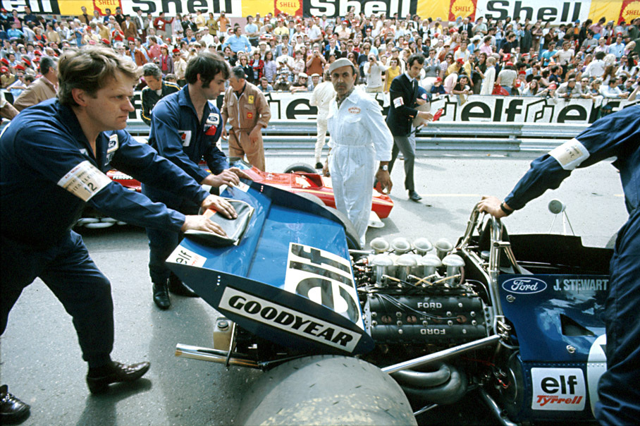 Later race winner Jackie Stewart's Tyrrell-Cosworth 003 is being prepared on second grid position