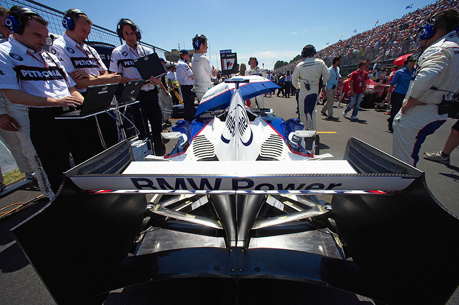 BMW engineers finishing the chip setup on the grid