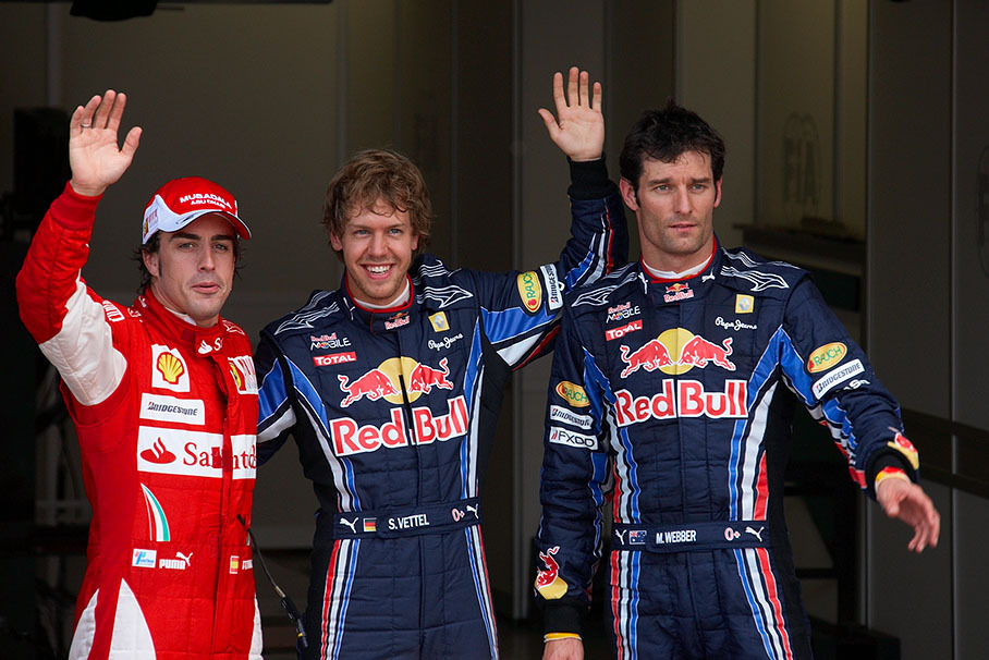 The fastest three qualifiers wave at the world's media after qualifying for the British GP 2010: on the left hand third qualified Alonso of Ferrari, Sebastian Vettel as polesetter in the middle and his Red Bull team mate Webber as second on the grid