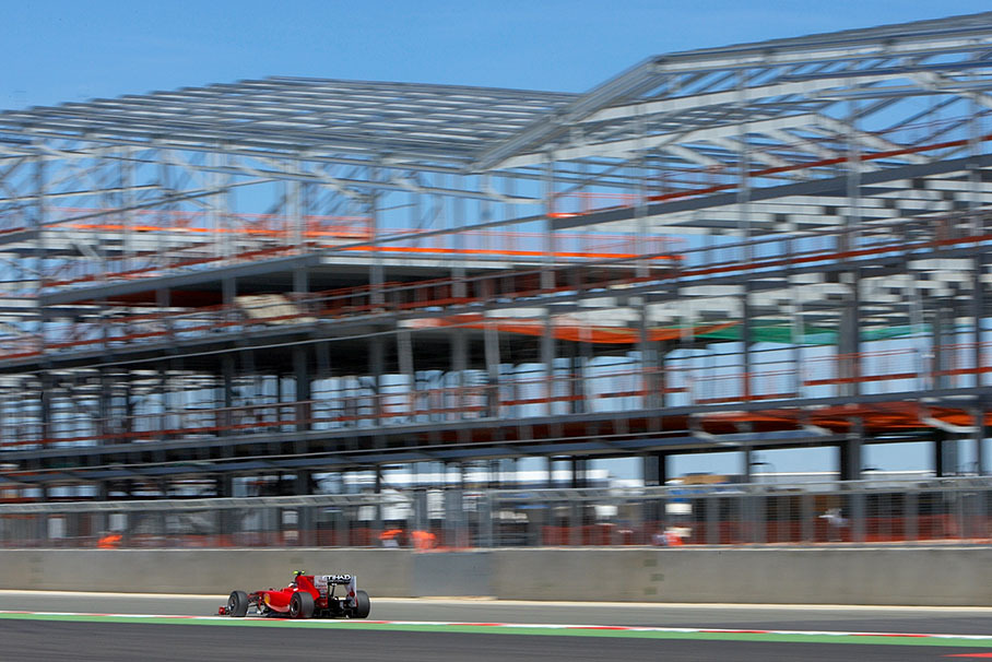 Felipe Massa, Ferrari, passes the framing of a new pit building