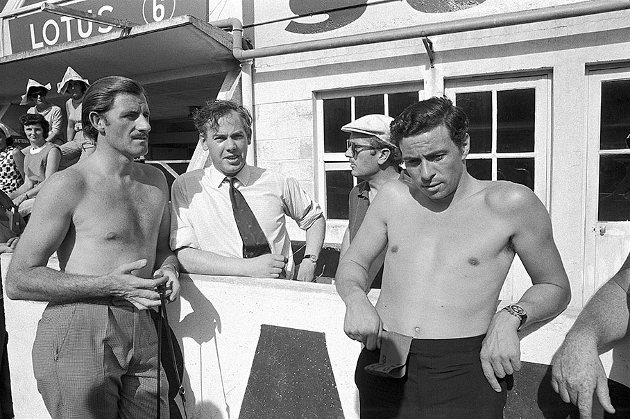 The Lotus team enjoys the sunshine before the start of a practice session: Graham Hill, Keith Duckworth, Colin Chapman and Jim Clark