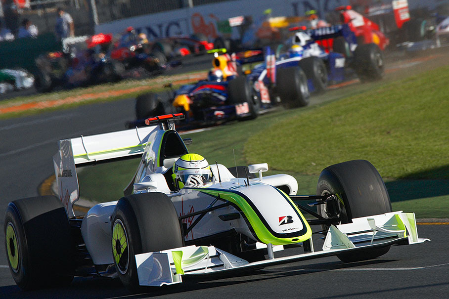 Jenson Button exits the first chicane after the start, far in front of Vettel and Rosberg